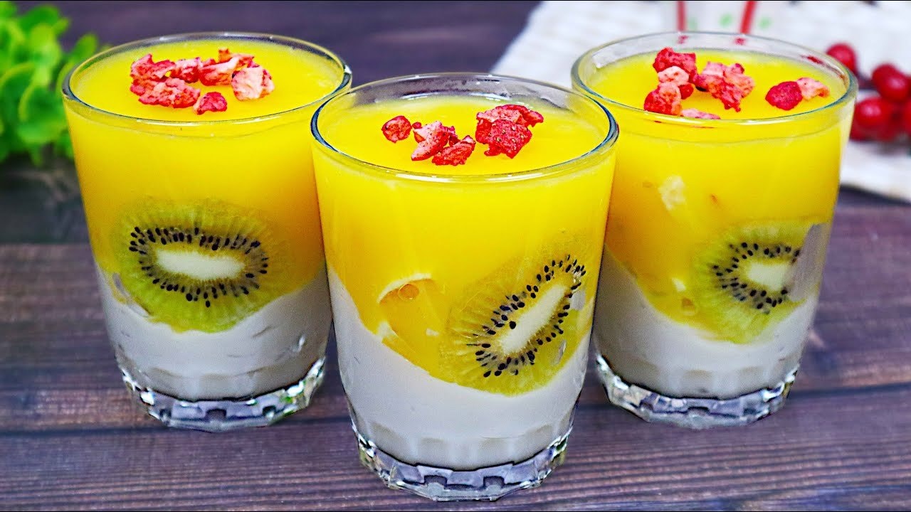 Vegan Orange Almond Panna Cotta Jars (Gluten-Free) — Angled jars of vanilla almond-milk panna cotta topped with fresh fruit and a bri